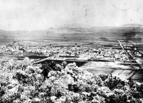 his view of downtown Carson City looks down from an outcropping of rock partway up C Hill.  1870-1880